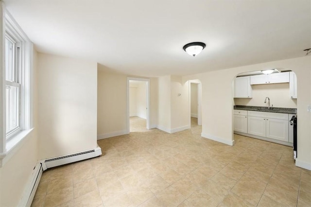 54 Harrison St, Pawtucket, RI 02860 - unfurnished living room with arched walkways and baseboard heating