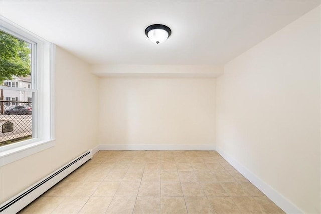 54 Harrison St, Pawtucket, RI 02860 - empty room featuring a baseboard heating unit and light tile patterned floors