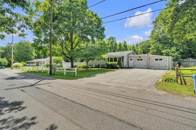 144 Hines Rd, Cumberland, RI 02864 - view of front of house with asphalt driveway, a garage, and view of wooded area