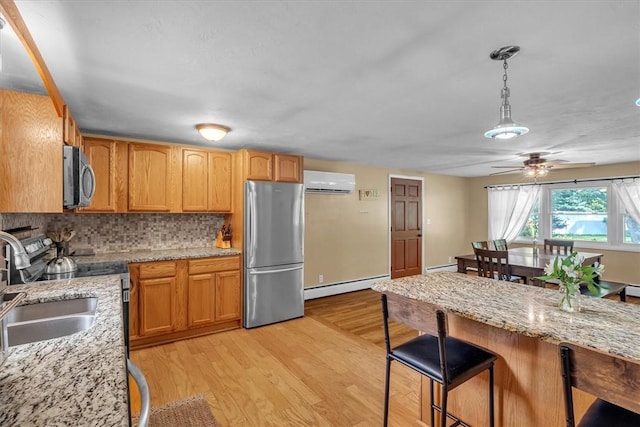 144 Hines Rd, Cumberland, RI 02864 - kitchen with stainless steel appliances, a baseboard radiator, an AC wall unit, tasteful backsplash, and a ceiling fan