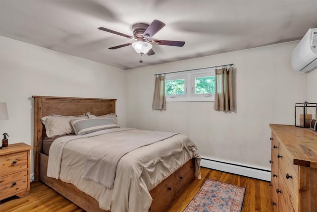 144 Hines Rd, Cumberland, RI 02864 - bedroom featuring baseboard heating, an AC wall unit, light wood-style flooring, and ceiling fan