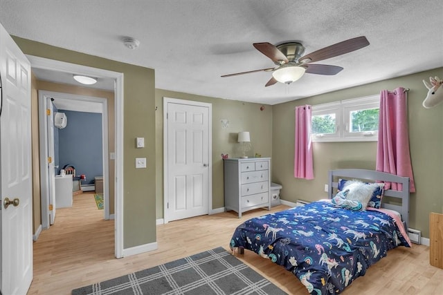 144 Hines Rd, Cumberland, RI 02864 - bedroom with wood finished floors, a baseboard heating unit, ceiling fan, and a textured ceiling