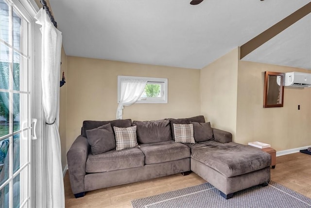 144 Hines Rd, Cumberland, RI 02864 - living area with a wall mounted air conditioner and light wood-type flooring