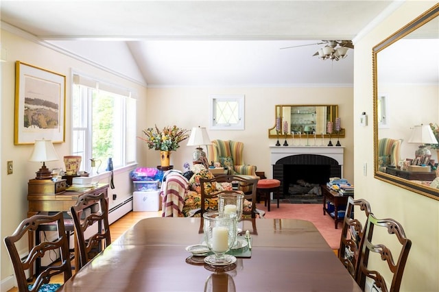 2 Quail Run, Westerly, RI 02891 - dining area featuring baseboard heating, a fireplace, crown molding, vaulted ceiling, and a ceiling fan