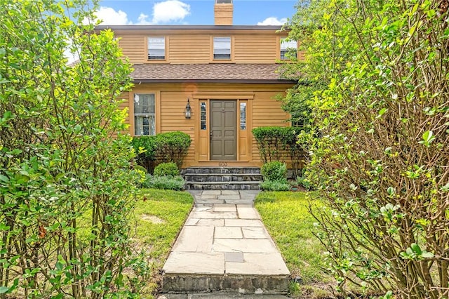 603 E Ave, Pawtucket, RI 02860 - view of front of house with entry steps and a chimney
