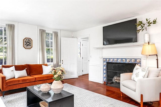 603 E Ave, Pawtucket, RI 02860 - living area with wood finished floors, healthy amount of natural light, and a tiled fireplace