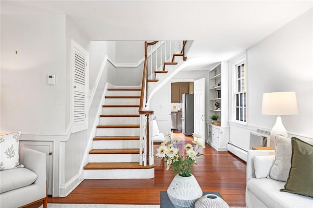 603 E Ave, Pawtucket, RI 02860 - staircase featuring built in features, wood finished floors, and baseboard heating