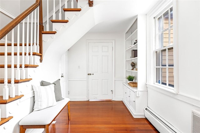 603 E Ave, Pawtucket, RI 02860 - hall featuring a baseboard heating unit, wood finished floors, stairway, and built in shelves