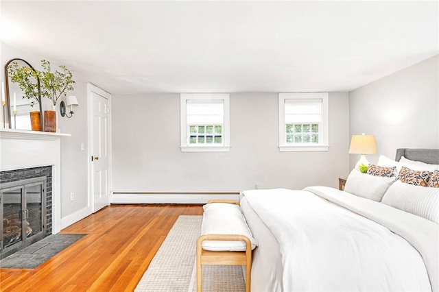 603 E Ave, Pawtucket, RI 02860 - bedroom with a baseboard radiator, a fireplace with flush hearth, and wood finished floors