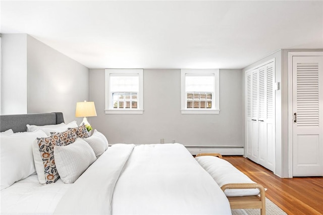 603 E Ave, Pawtucket, RI 02860 - bedroom with baseboard heating, wood finished floors, and multiple windows