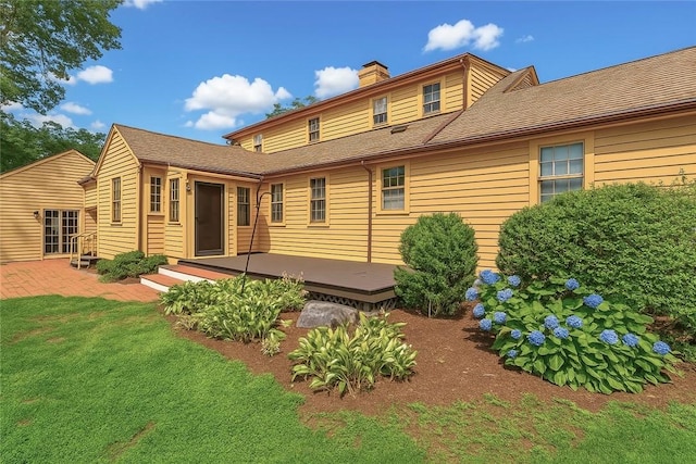 603 E Ave, Pawtucket, RI 02860 - rear view of property featuring a chimney, a wooden deck, and a yard