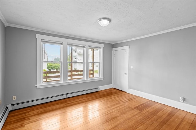 289 Mowry St, Woonsocket, RI 02895 - spare room featuring baseboard heating, hardwood / wood-style floors, crown molding, and a textured ceiling