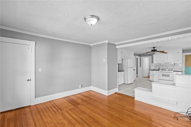 289 Mowry St, Woonsocket, RI 02895 - unfurnished living room with ornamental molding, light wood finished floors, ceiling fan, and a textured ceiling