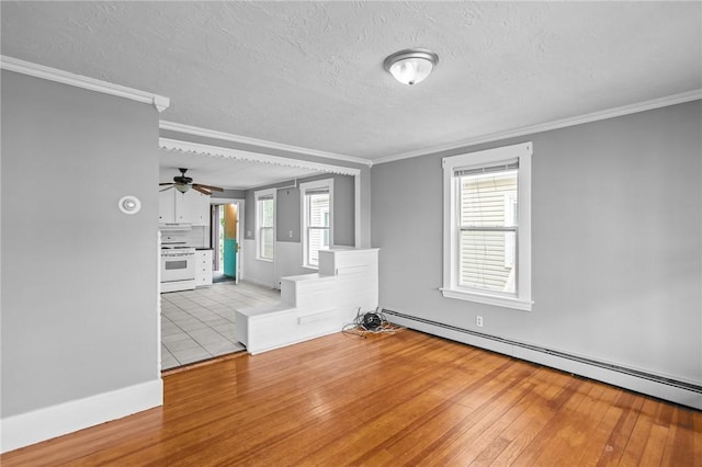 289 Mowry St, Woonsocket, RI 02895 - spare room with a baseboard radiator, hardwood / wood-style floors, a textured ceiling, ornamental molding, and ceiling fan