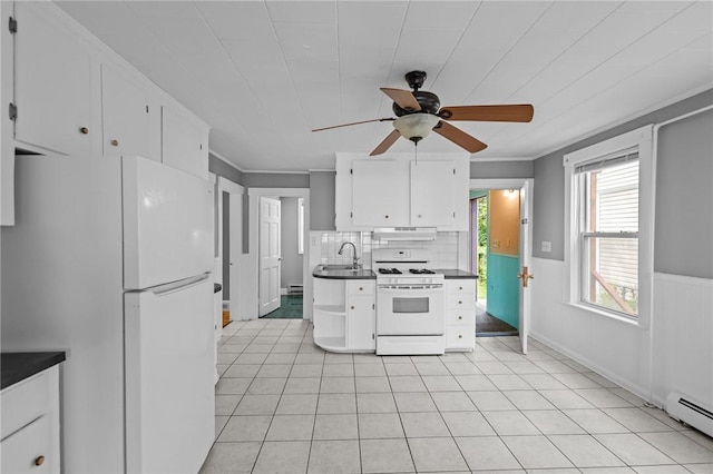 289 Mowry St, Woonsocket, RI 02895 - kitchen with white appliances, under cabinet range hood, dark countertops, a ceiling fan, and white cabinetry