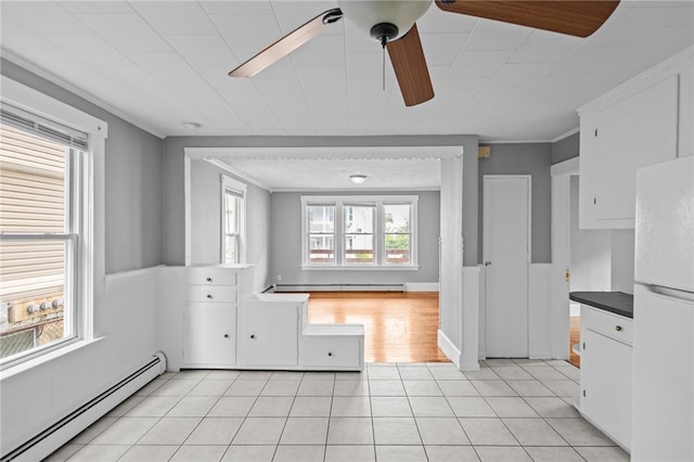 289 Mowry St, Woonsocket, RI 02895 - kitchen with a baseboard radiator, freestanding refrigerator, baseboard heating, ceiling fan, and light tile patterned floors