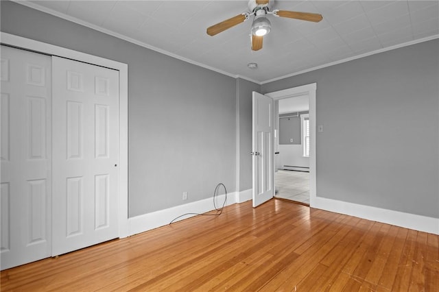 289 Mowry St, Woonsocket, RI 02895 - unfurnished bedroom featuring crown molding, light wood-style floors, a baseboard radiator, a ceiling fan, and a closet