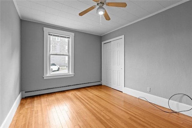 289 Mowry St, Woonsocket, RI 02895 - unfurnished bedroom with baseboard heating, crown molding, light wood-style flooring, a closet, and ceiling fan