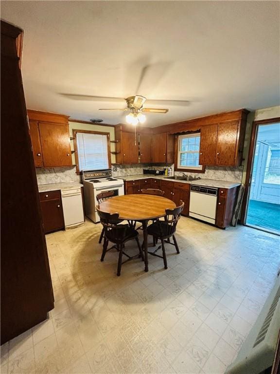 51 Benjamin St, Pawtucket, RI 02861 - kitchen featuring white appliances, tasteful backsplash, light countertops, ceiling fan, and light floors