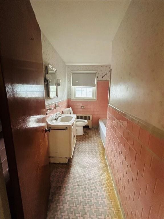 51 Benjamin St, Pawtucket, RI 02861 - full bathroom with radiator heating unit, vanity, a bath, a wainscoted wall, and tile walls
