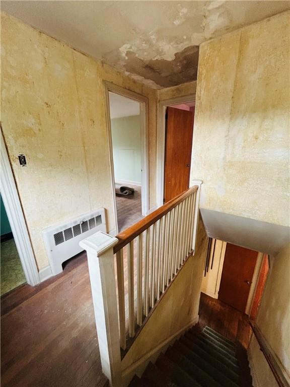 51 Benjamin St, Pawtucket, RI 02861 - stairs with radiator and wood finished floors