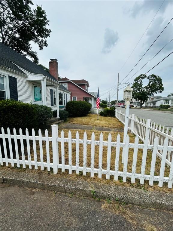51 Benjamin St, Pawtucket, RI 02861 - view of front of home with a chimney and a fenced front yard