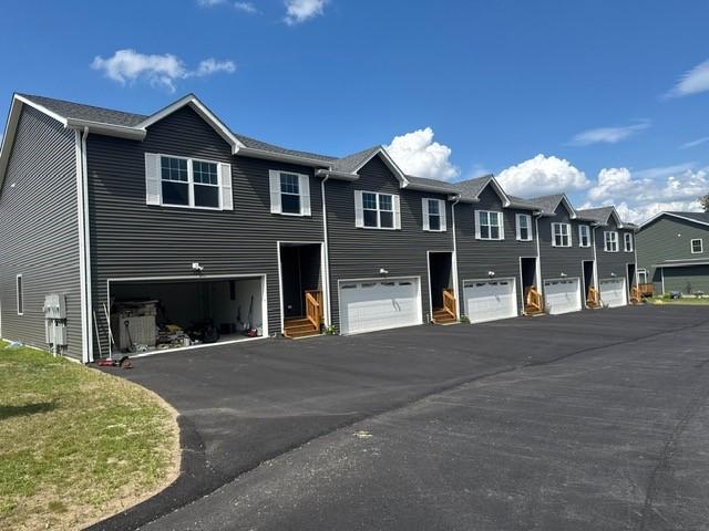 99 Ayda Rose Ave, West Warwick, RI 02893 - view of side of home featuring a garage, asphalt driveway, and a residential view