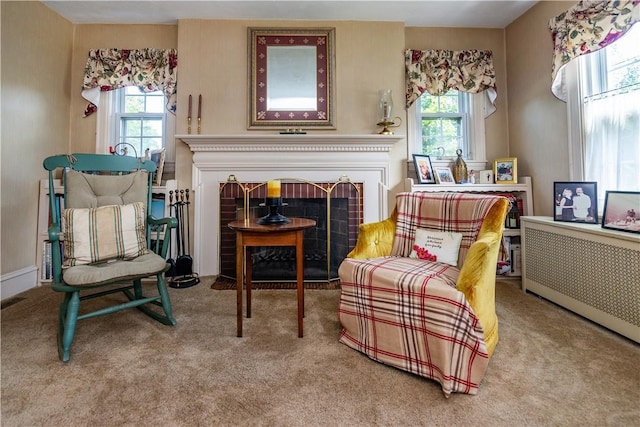 64 Riverfarm Rd, Cranston, RI 02910 - living area featuring a fireplace with flush hearth, plenty of natural light, radiator, and carpet flooring