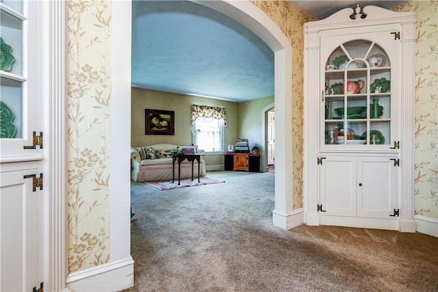 64 Riverfarm Rd, Cranston, RI 02910 - entryway featuring wallpapered walls, carpet, and arched walkways