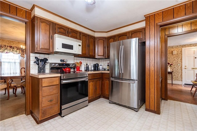 64 Riverfarm Rd, Cranston, RI 02910 - kitchen featuring stainless steel appliances, light countertops, backsplash, and brown cabinets