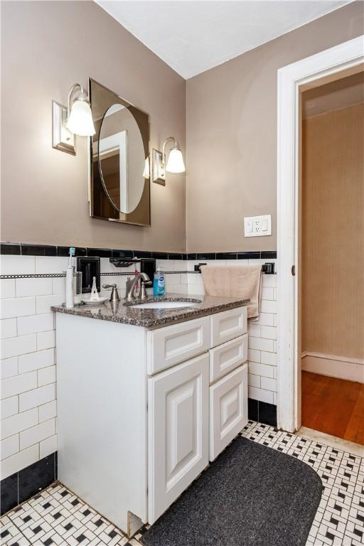 64 Riverfarm Rd, Cranston, RI 02910 - bathroom with tile walls, vanity, a wainscoted wall, and tile patterned flooring