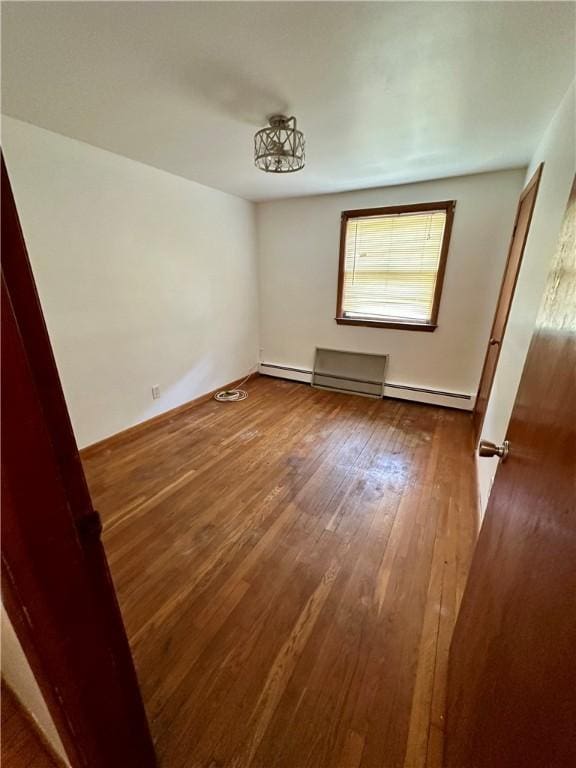 103 Windsor Park Dr, Coventry, RI 02816 - spare room with wood-type flooring, a baseboard radiator, and baseboard heating