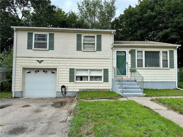 103 Windsor Park Dr, Coventry, RI 02816 - tri-level home featuring entry steps, an attached garage, and asphalt driveway