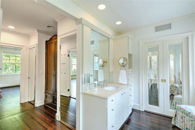 29 Orchard Ave, Providence, RI 02906 - bathroom featuring french doors, crown molding, hardwood / wood-style floors, vanity, and baseboard heating