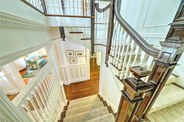 29 Orchard Ave, Providence, RI 02906 - staircase featuring a decorative wall, wood finished floors, and a high ceiling