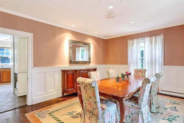 29 Orchard Ave, Providence, RI 02906 - dining area featuring wood finished floors, a wainscoted wall, a baseboard heating unit, a decorative wall, and recessed lighting