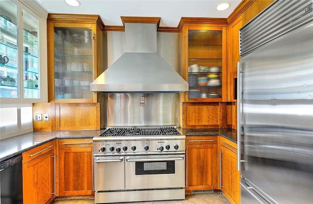 29 Orchard Ave, Providence, RI 02906 - kitchen with premium appliances, wall chimney exhaust hood, brown cabinetry, glass insert cabinets, and recessed lighting