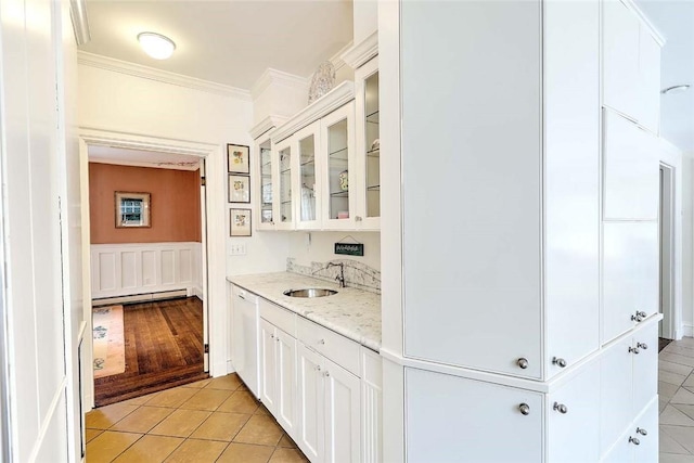 29 Orchard Ave, Providence, RI 02906 - bar featuring baseboard heating, ornamental molding, light tile patterned floors, white dishwasher, and wainscoting