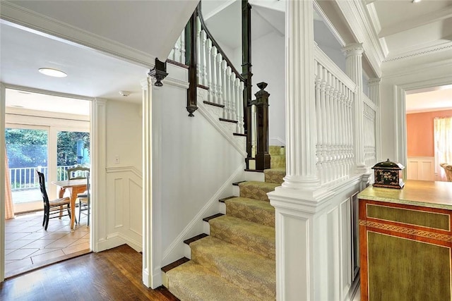 29 Orchard Ave, Providence, RI 02906 - staircase featuring crown molding, a decorative wall, decorative columns, wainscoting, and wood finished floors