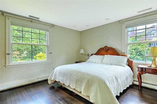 29 Orchard Ave, Providence, RI 02906 - bedroom featuring dark wood finished floors, multiple windows, a baseboard heating unit, and baseboard heating