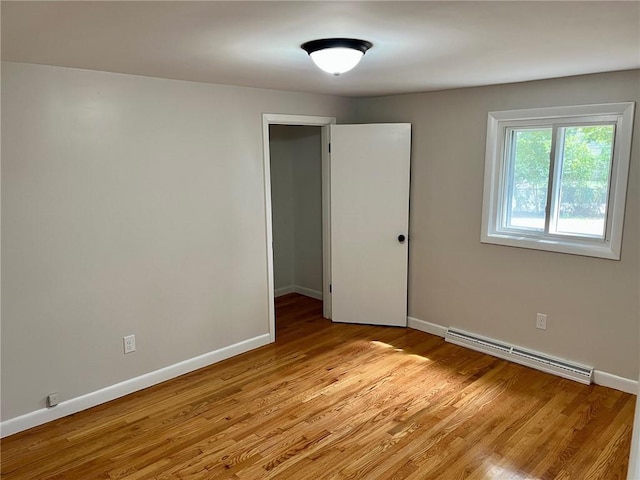 18 Louisiana Ave, Warwick, RI 02888 - spare room featuring a baseboard heating unit and light wood-style flooring