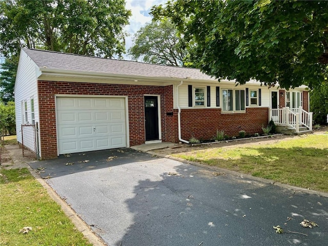 18 Louisiana Ave, Warwick, RI 02888 - view of front of house with an attached garage, brick siding, asphalt driveway, and a front lawn