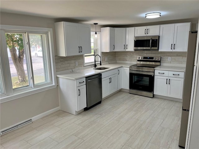 18 Louisiana Ave, Warwick, RI 02888 - kitchen with appliances with stainless steel finishes, backsplash, light countertops, and white cabinets