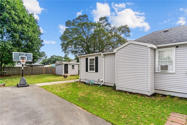 160 Coburn St, Warwick, RI 02889 - view of home's exterior featuring a shed, a shingled roof, a patio, and cooling unit