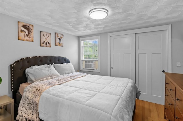 160 Coburn St, Warwick, RI 02889 - bedroom with light wood-type flooring, cooling unit, and a closet
