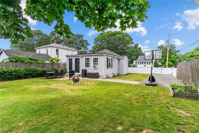 160 Coburn St, Warwick, RI 02889 - rear view of property with a fenced backyard, a garden, a gate, a patio area, and an outdoor fire pit