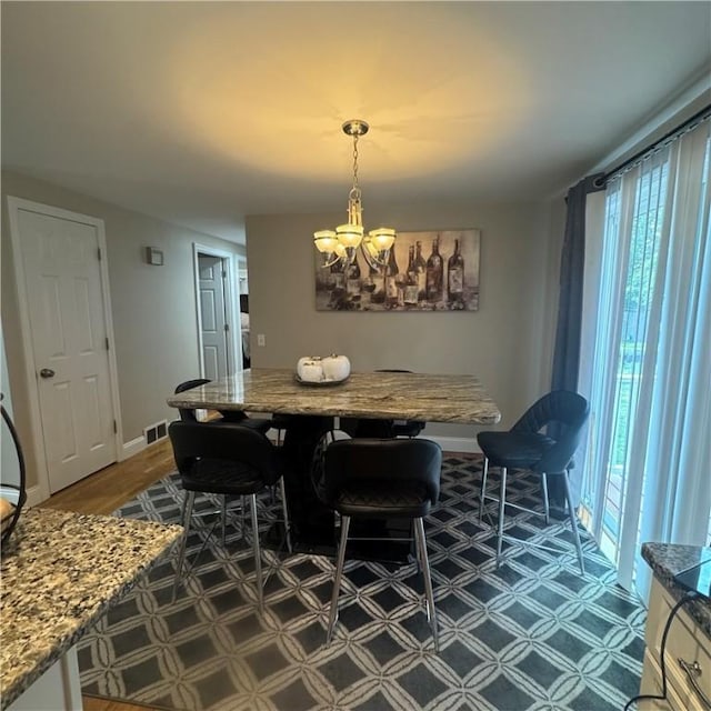 34 Ridge St, East Providence, RI 02914 - dining room featuring a chandelier and baseboards