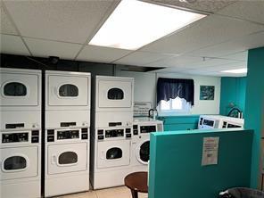 1190 Charles St Unit 9, North Providence, RI 02904 - community laundry with stacked washing machine and dryer, washing machine and clothes dryer, and tile patterned flooring