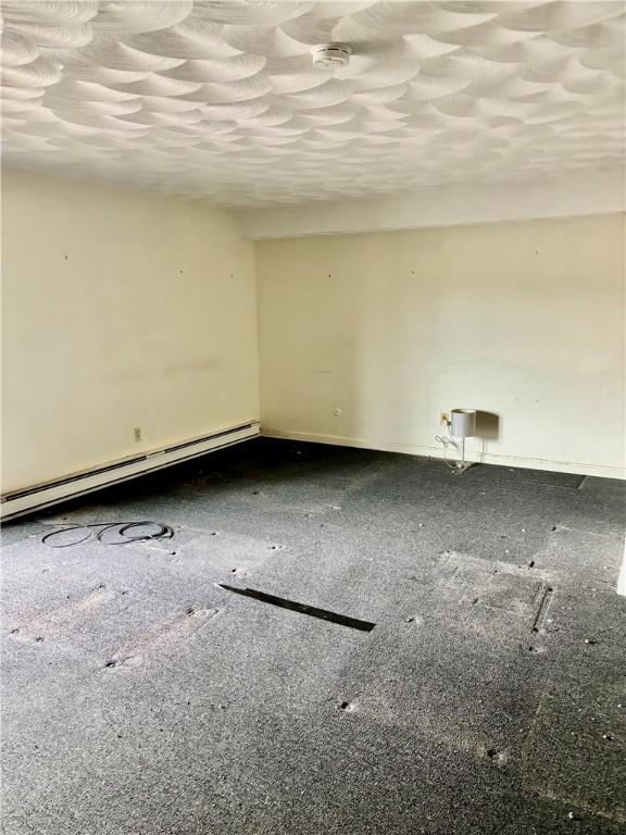1190 Charles St Unit 9, North Providence, RI 02904 - unfurnished room featuring baseboard heating and a smoke detector