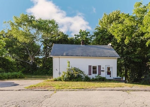 15 Hope Ct, West Warwick, RI 02893 - view of front of house with a chimney and a front lawn